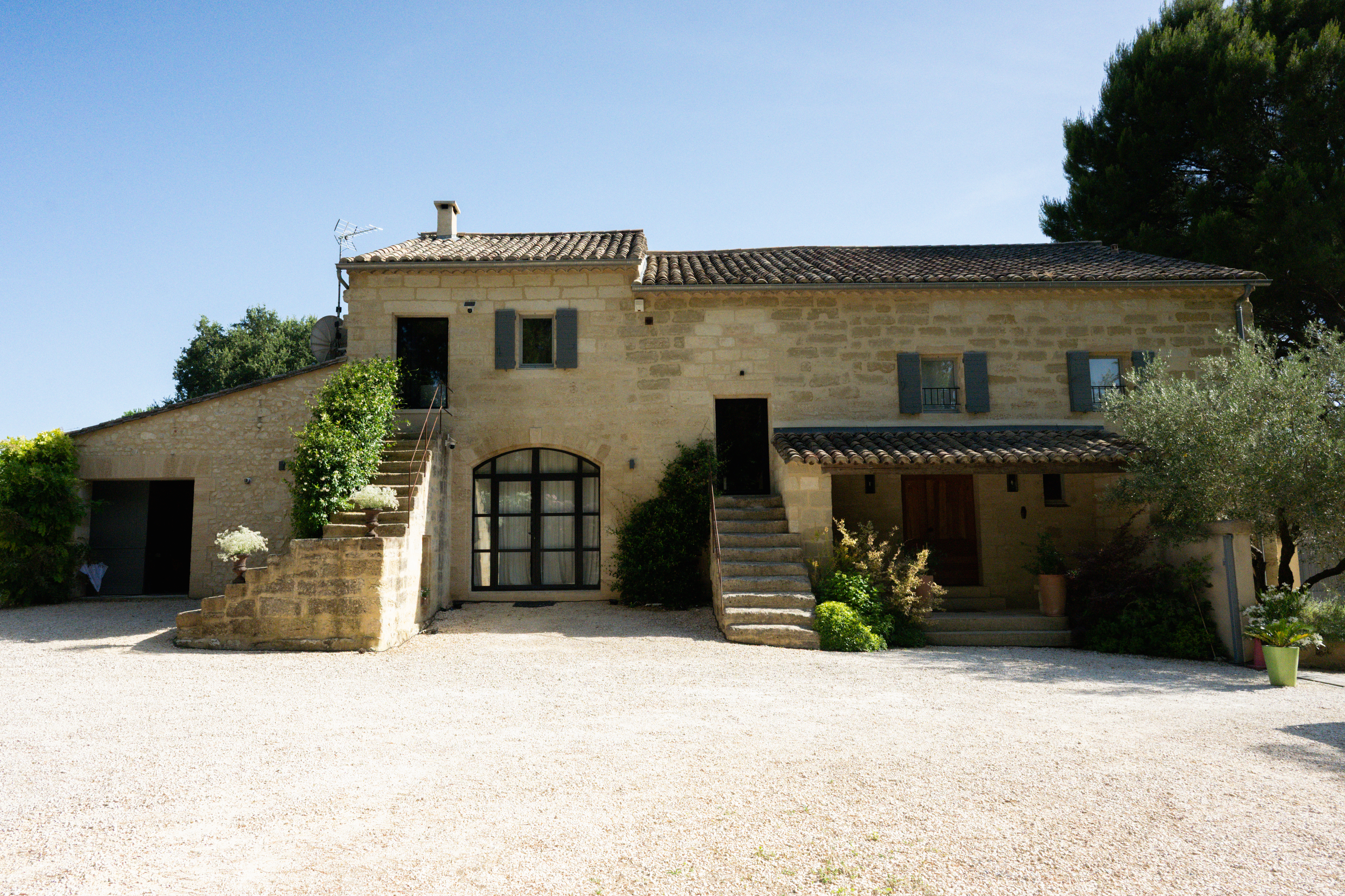 The stone façade of La Bergerie with its two outside staircases